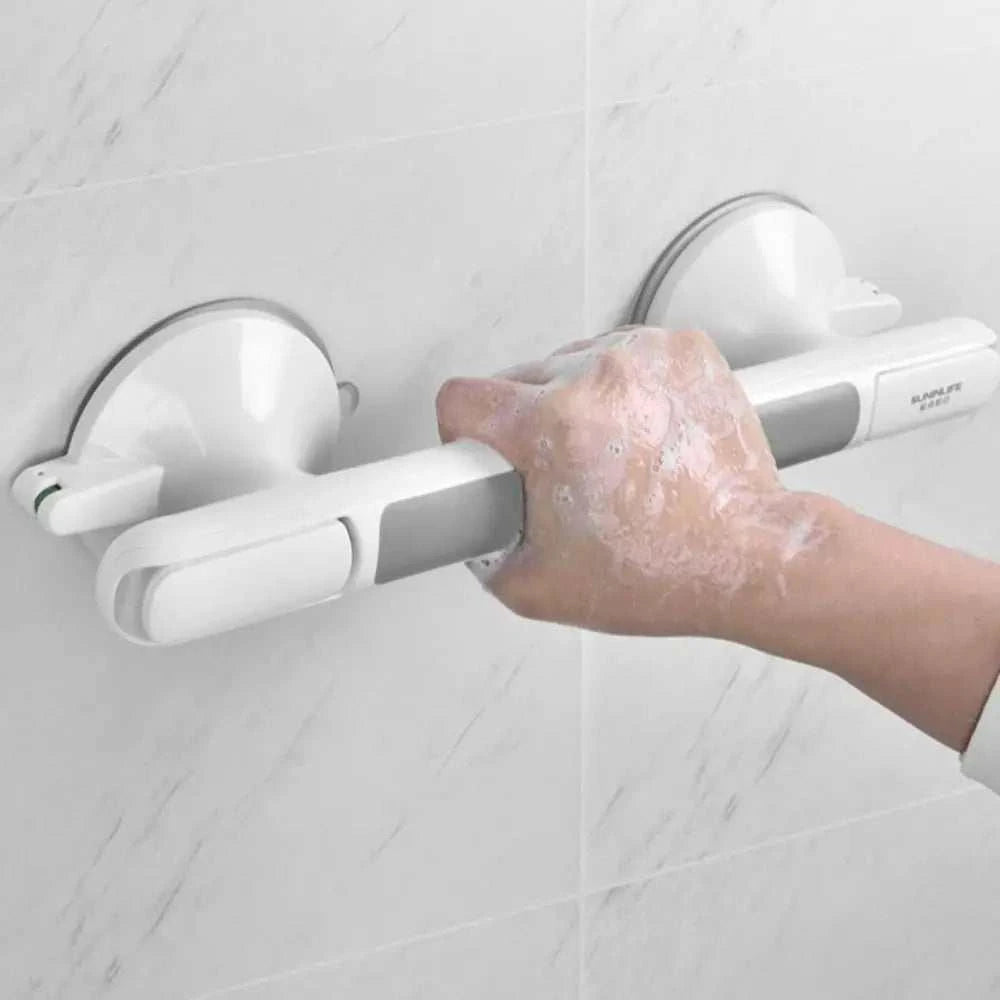 Safety ultra grip shower handle with suction cups installed on bathroom tiles for elderly and children.